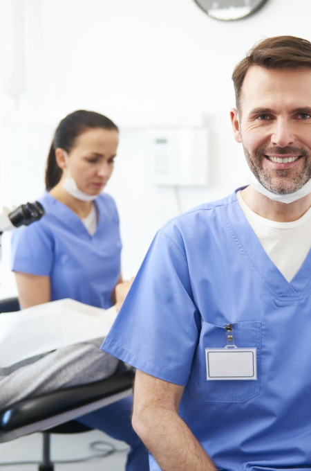 portrait-of-smiling-male-dentist-in-dentist-s-clinic.jpg