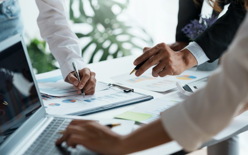 business-people-pointing-to-graph-and-chart-to-analyze-market-sale-balance-sheet-account-net-pro.jpg