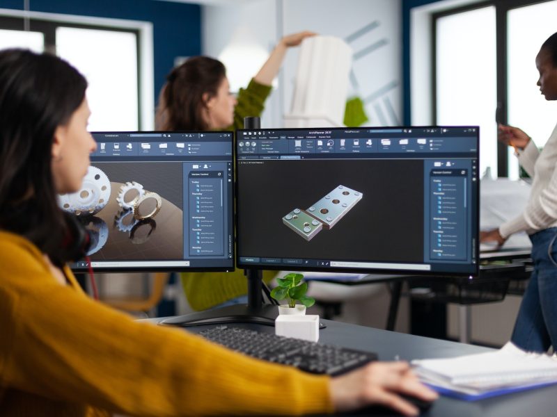 industrial-engineer-woman-working-at-pc-with-two-monitors-screens-showing-cad-software.jpg
