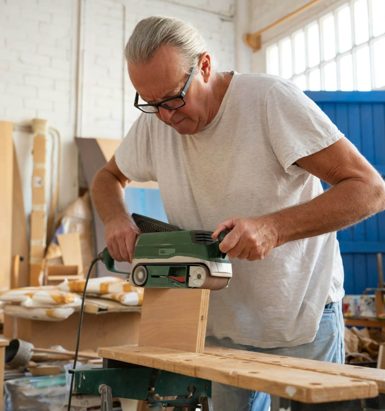 carpenter-working-on-wood-craft-at-workspace-producing-wooden-furniture-.jpg