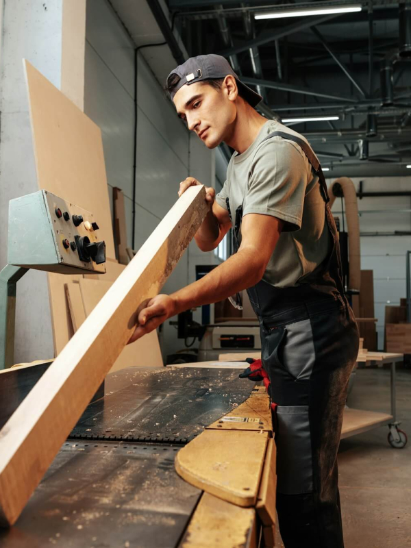 young-carpenter-working-on-woodworking-machines-in-the-furniture-factory.jpg
