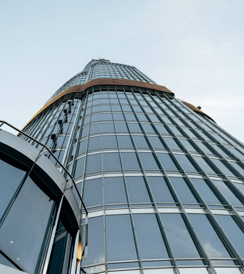 tall-glass-building-against-blue-sky-view-from-th-2023-11-27-05-02-25-utc.jpg
