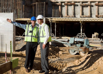 two-construction-workers-discussing-plans-on-site-2024-06-05-18-36-48-utc_11zon.jpg